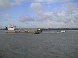 A commercial ferry passes a Thames fishing vessel